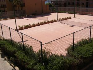 a tennis court with a tennis racket on it at Le Nereidi Hotel Residence in La Maddalena