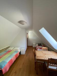 a room with two beds and a table in it at Apartamenty Ogrodowa in Jastarnia