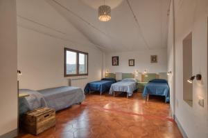 En eller flere senger på et rom på Ostello Portabene