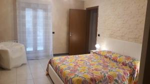 a bedroom with a bed with a colorful blanket at LA DIMORA DI MARIA in Ortona