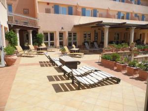 a patio area with a patio table and chairs at Le Nereidi Hotel Residence in La Maddalena