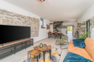 a living room with a large flat screen tv at VILLA FIORE in Marušići
