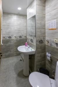 a bathroom with a sink and a toilet at GP Rooms in Stepantsminda