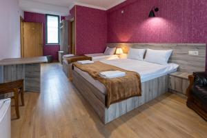 a hotel room with two beds and a couch at GP Rooms in Stepantsminda