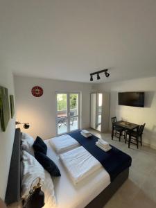 a bedroom with a large bed and a table at Dom Lovrenko in Mlini