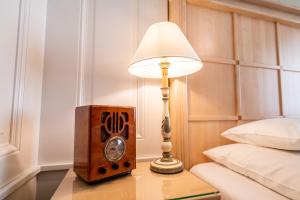 a lamp sitting on a table next to a bed at Hotel König von Ungarn in Vienna