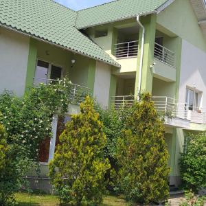 a house with trees in front of it at Ramhouse in Piteşti