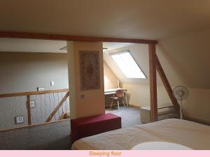 ein Schlafzimmer mit einem Bett und einem Schreibtisch in einem Zimmer in der Unterkunft Maison de la Sauer - Bed and Breakfast | Chambre d’hôtes | Ferienhaus in Munchhausen