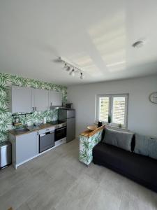a living room with a couch and a kitchen at Dom Lovrenko in Mlini