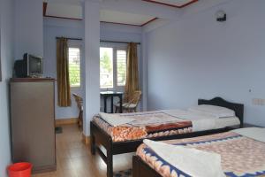 Giường trong phòng chung tại Nanohana Lodge