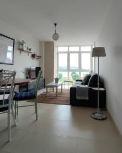 a living room with a couch and a table at Casa Charo - Sardiñeiro in Fisterra