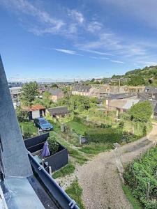 a view of a city from the balcony of a house at Les Mouettes. Appart Honfleur 4 personnes vue pont de Normandie in Honfleur