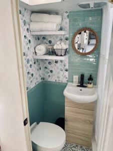 a small bathroom with a toilet and a sink at Rustic Farm Stay in Temecula