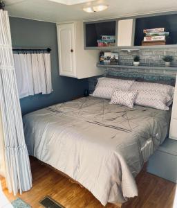 a bed in a small room with blue walls at Rustic Farm Stay in Temecula