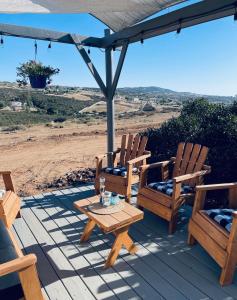 a patio with two chairs and a table and an umbrella at Rustic Farm Stay in Temecula
