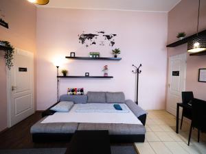 a bedroom with a large bed and shelves on the wall at Better Than Home Apartment Budapest in Budapest