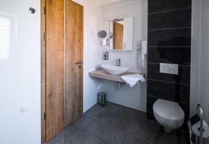 a bathroom with a white toilet and a sink at Füred Centrum Panzió in Balatonfüred