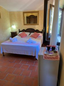 a bedroom with a bed and a table with a table at Angelo e Arcangela in Telti