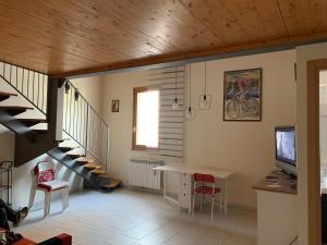 ein Wohnzimmer mit einer Treppe, einem Tisch und Stühlen in der Unterkunft TRA IL CENTRO E IL MARE in Senigallia