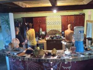 a group of people in a kitchen preparing food at Hostel Del Lago Yojoa Backpackers in Agua Azul