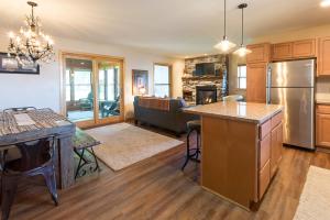a kitchen and living room with a refrigerator freezer at Gull Haven 700 in Nisswa
