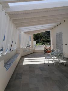 a patio with a table and chairs on a roof at Villa Portinente in Lipari