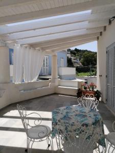 a patio with a table and chairs on a roof at Villa Portinente in Lipari