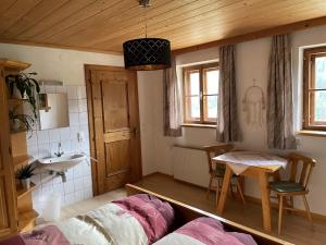 Zimmer mit einem Bett, einem Waschbecken und einem Tisch in der Unterkunft Ferienwohnung Peintnerhof in Innervillgraten