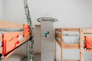 a bedroom with two bunk beds and a sign that reads beach house at Endless Summer House in Adeje