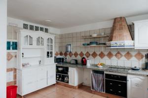 a kitchen with white cabinets and a counter top at Endless Summer House in Adeje