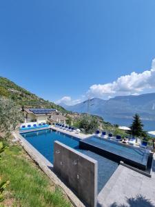 a swimming pool with a view of the water at Villa Anna Apartments in Tremosine Sul Garda