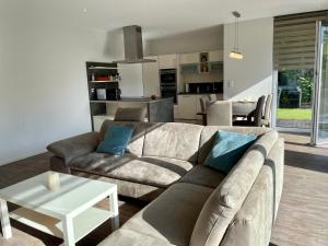a living room with a couch and a table at Ferienwohnung An Bord in Dangast