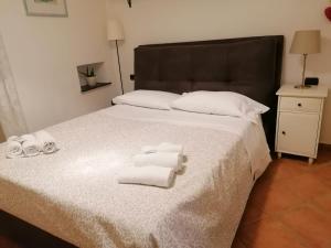 a bedroom with a bed with towels on it at PERLA DEL GOLFO (con Box Auto) in Lerici