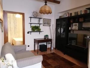a living room with a couch and a table at PERLA DEL GOLFO (con Box Auto) in Lerici