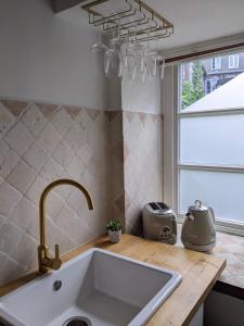 a kitchen counter with a sink and a window at BacksteinFlair - LüneMitte in Lüneburg