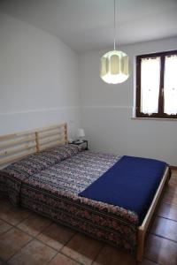 A bed or beds in a room at Appartamenti il PALAZZACCIO