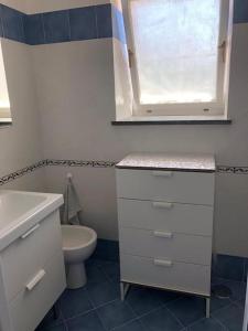 a bathroom with a white sink and a toilet at Lilli's House in Capri in Capri +21 photos