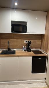 a kitchen with a sink and a microwave at Ivet Guest rooms in Varna City