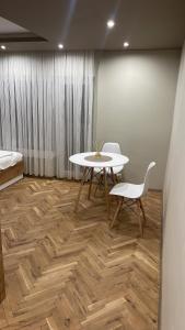 a room with a table and chairs and a bed at Ivet Guest rooms in Varna City