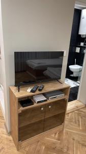 a wooden entertainment center in a living room at Ivet Guest rooms in Varna City
