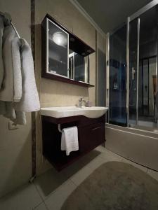 a bathroom with a sink and a mirror and a shower at Hotel complex Lenivaya Vera in Novaki +44 photos