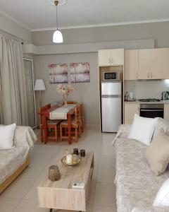 a living room with a couch and a table at Lovely Sea View Apartments & Junior Suites in Himare