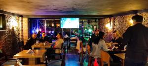 a group of people sitting at tables in a restaurant at Istanbul Harmony Hostel in Istanbul