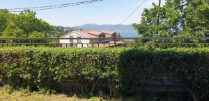 a hedge in front of a house next to a building at Apartman No 1 in Sretenovo