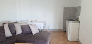a living room with a couch and a table at Apartman No 1 in Sretenovo