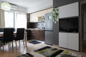 a kitchen with a table and a tv in a kitchen at Katja Apartment in Zadar
