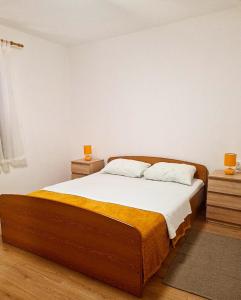 a bedroom with a large bed with two night stands at Holiday House Lili in Vrsi