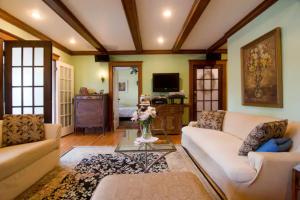 a living room with two couches and a tv at Victorian Condo in Boston