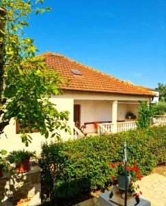 a white house with a red roof at Holiday House Lili in Vrsi