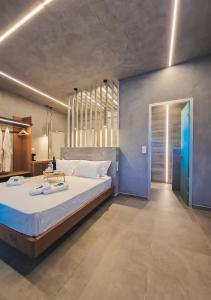 a large bedroom with a large bed with white sheets at Viva Mare Studios in Astypalaia
